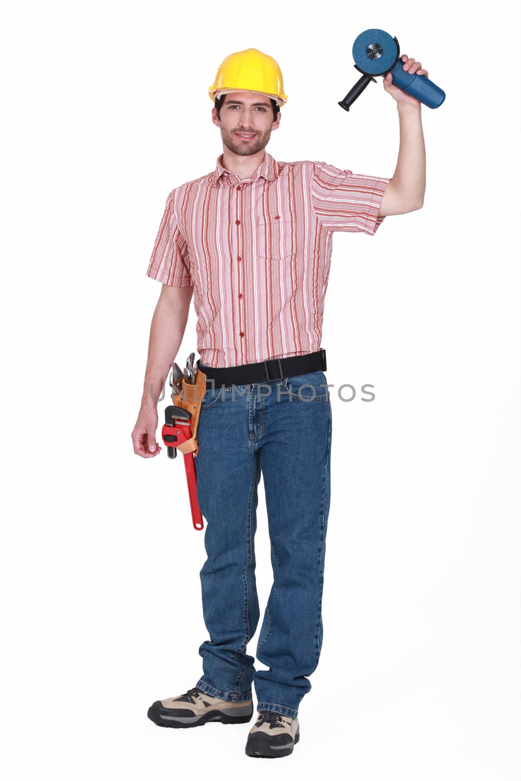 A handyman holding a grinding machine. by phovoir