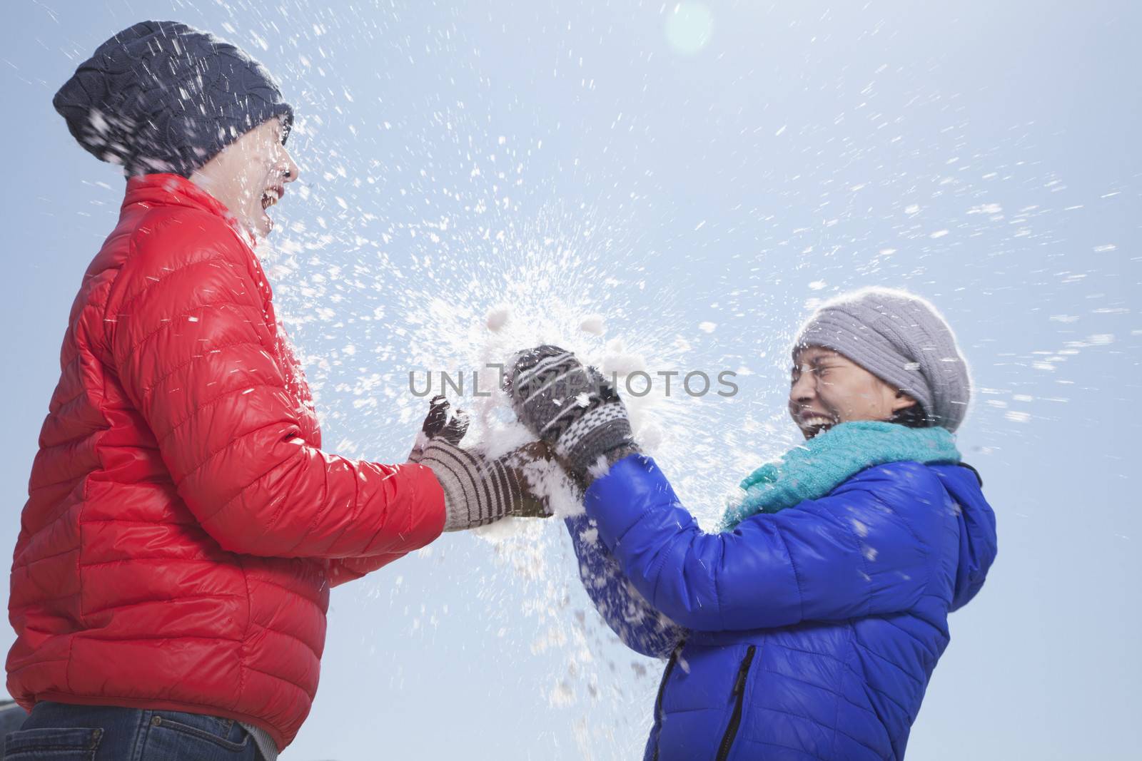 Two Young People Playing With Snow by XiXinXing
