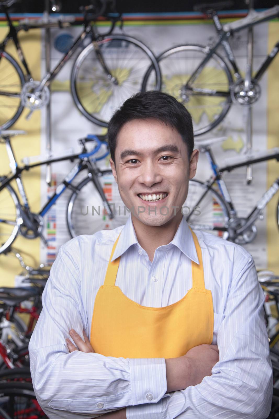 Portrait of young male mechanic in bicycle store, Beijing