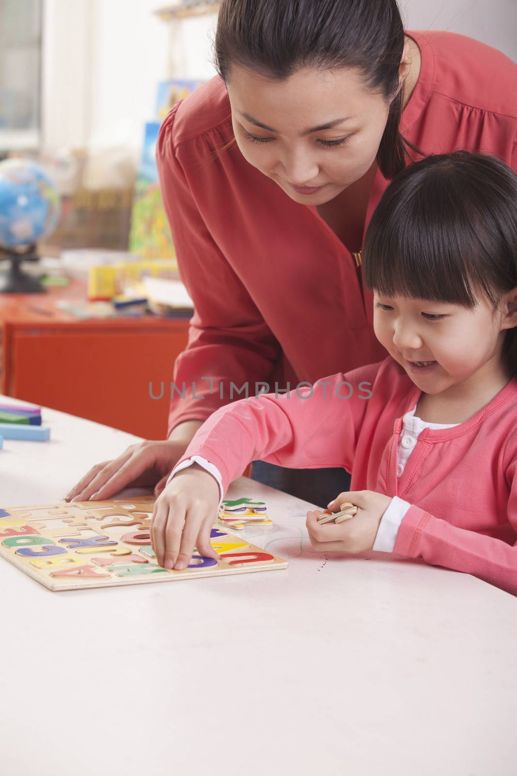Teaching Helping Young Girl with Cut-Out Alphabet Letters by XiXinXing