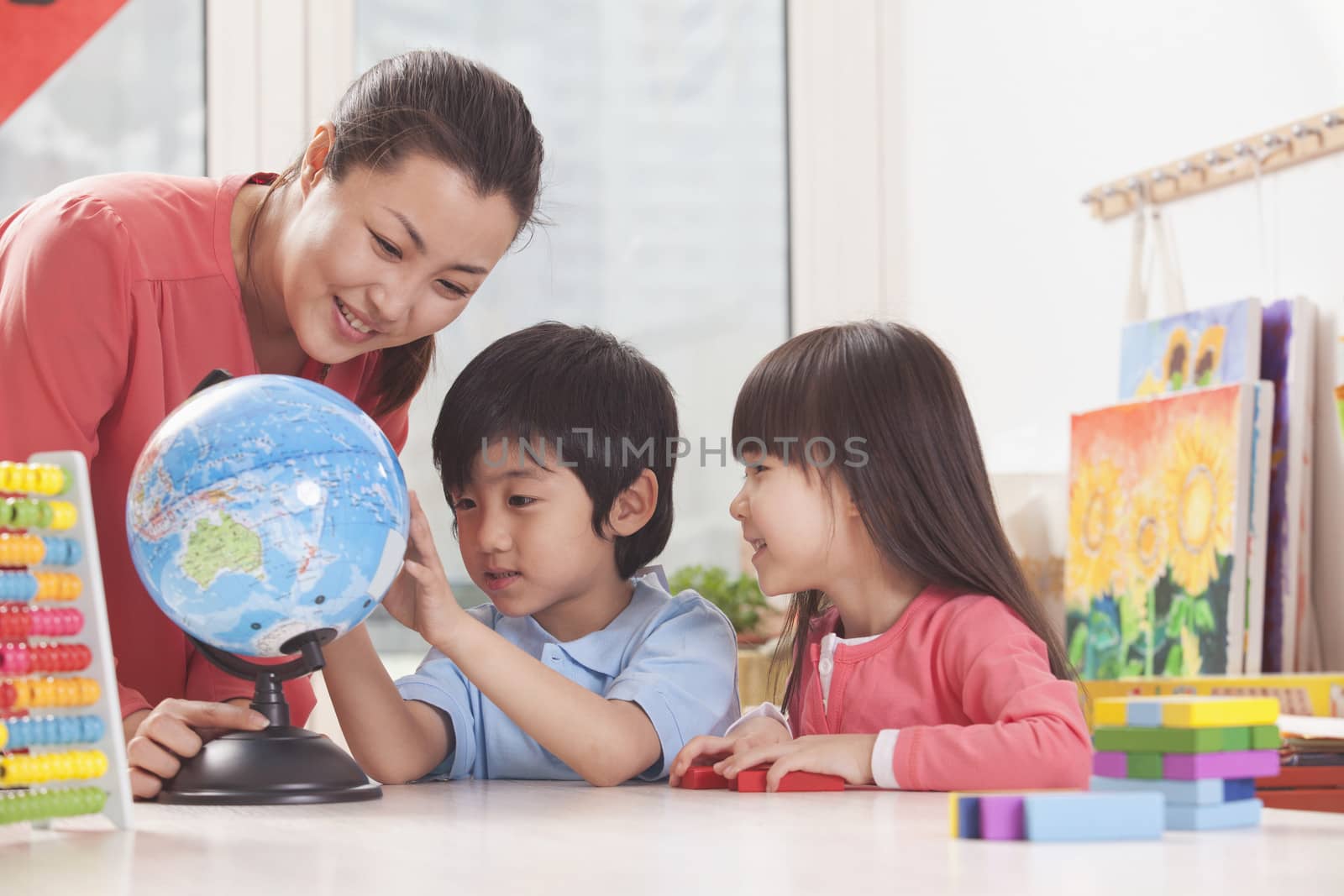 Students And Teacher Looking at Globe by XiXinXing