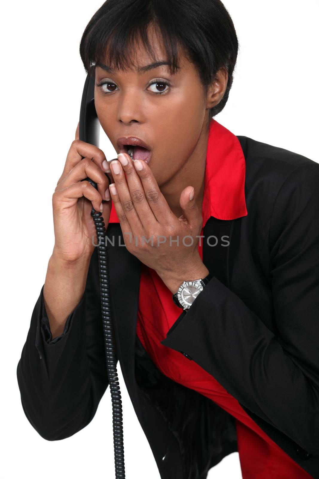 Surprised woman on the telephone by phovoir