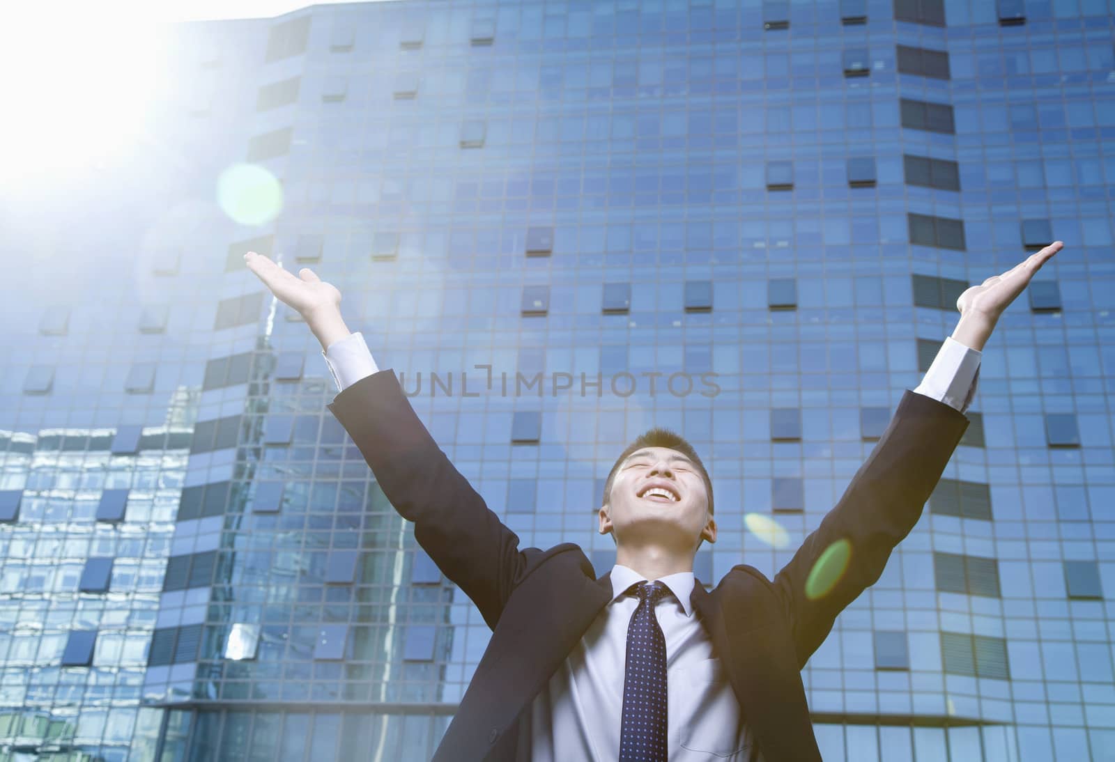 Young Businessman with arms raised