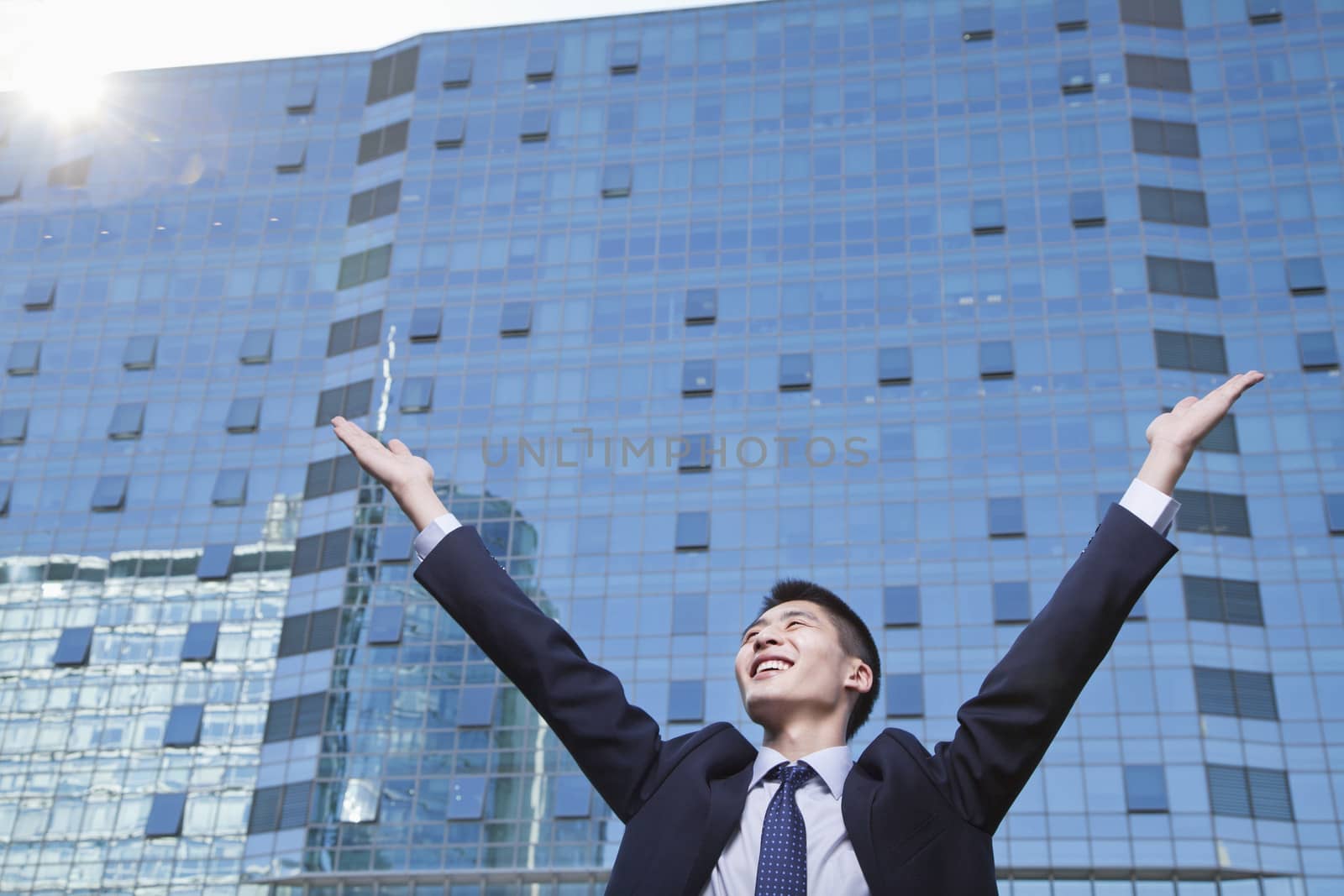 Young Businessman with arms raised