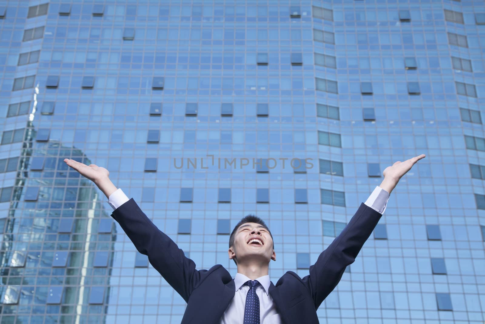 Young Businessman with arms raised