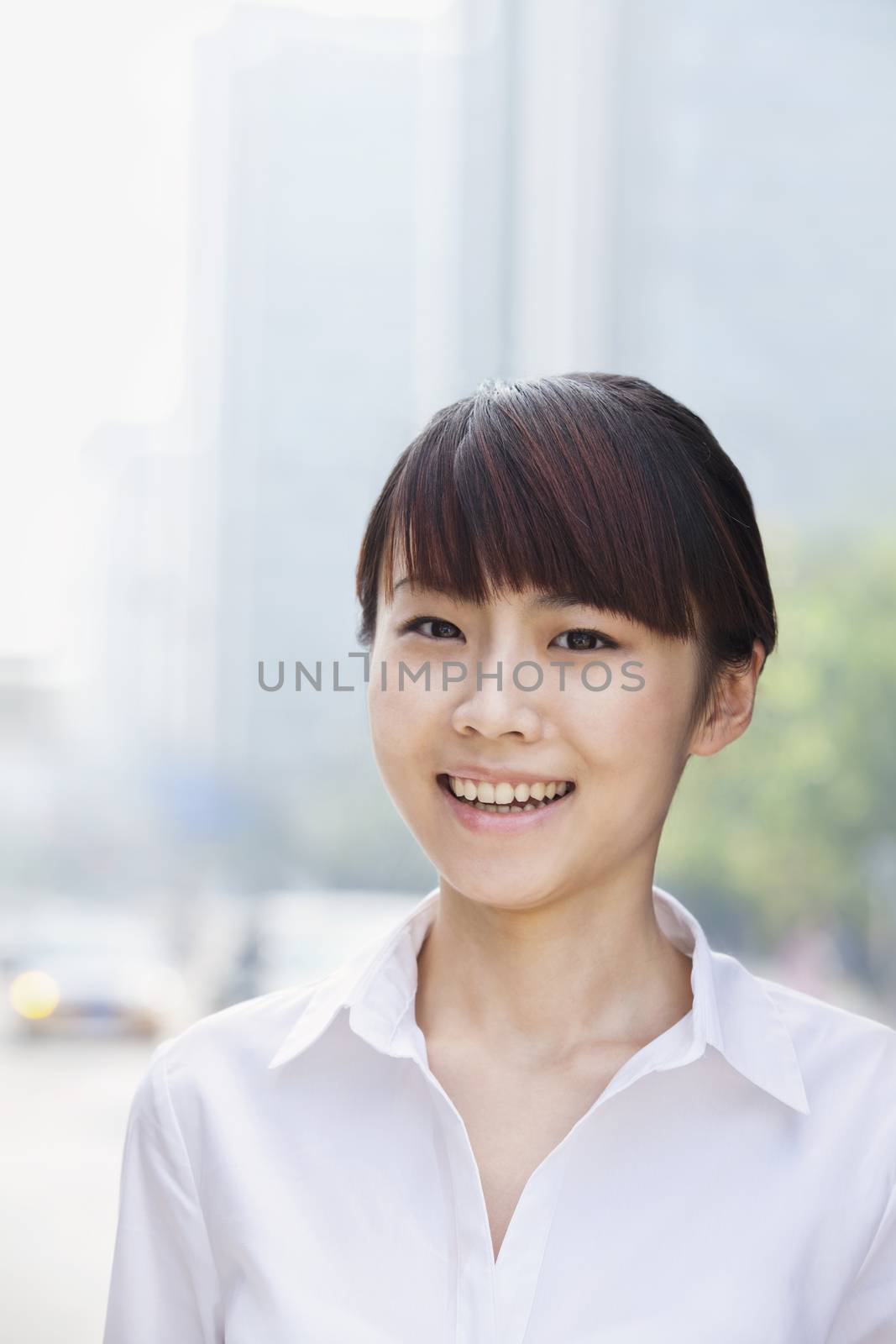 Portrait of young businesswoman smiling, Beijing