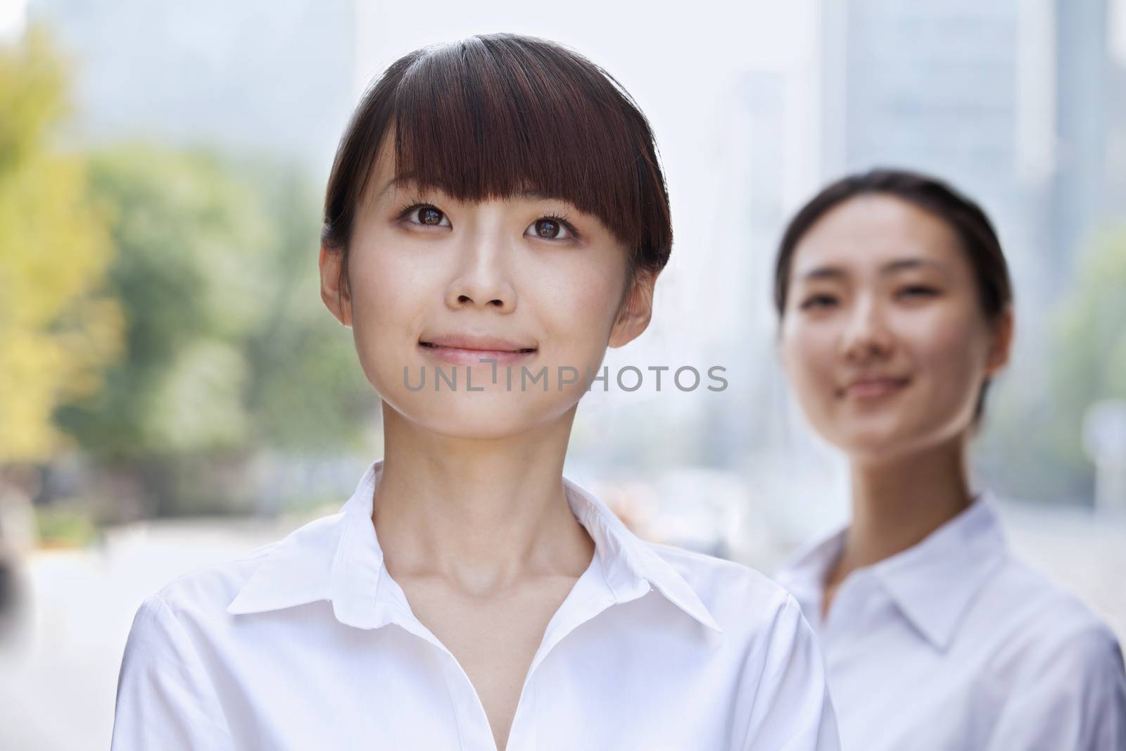 Portrait of young Businesswoman smiling in Beijing by XiXinXing