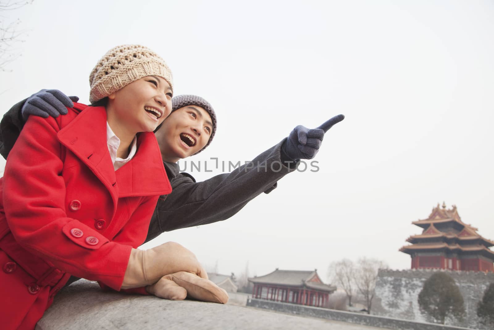 Young Couple In Beijing In Winter, Pointing off Screen