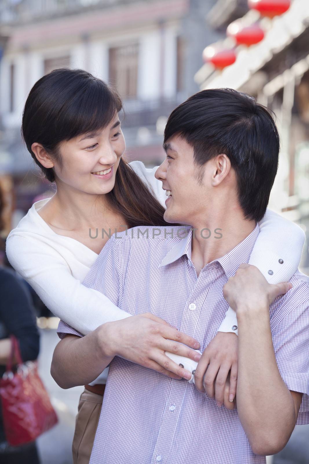 Young Heterosexual Couple Looking at Each Other Outdoors in Beijing by XiXinXing