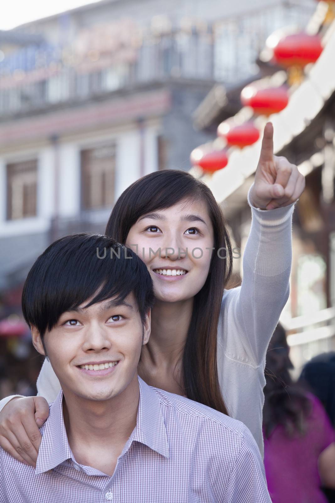 Young Heterosexual Couple Pointing Outdoors in Beijing