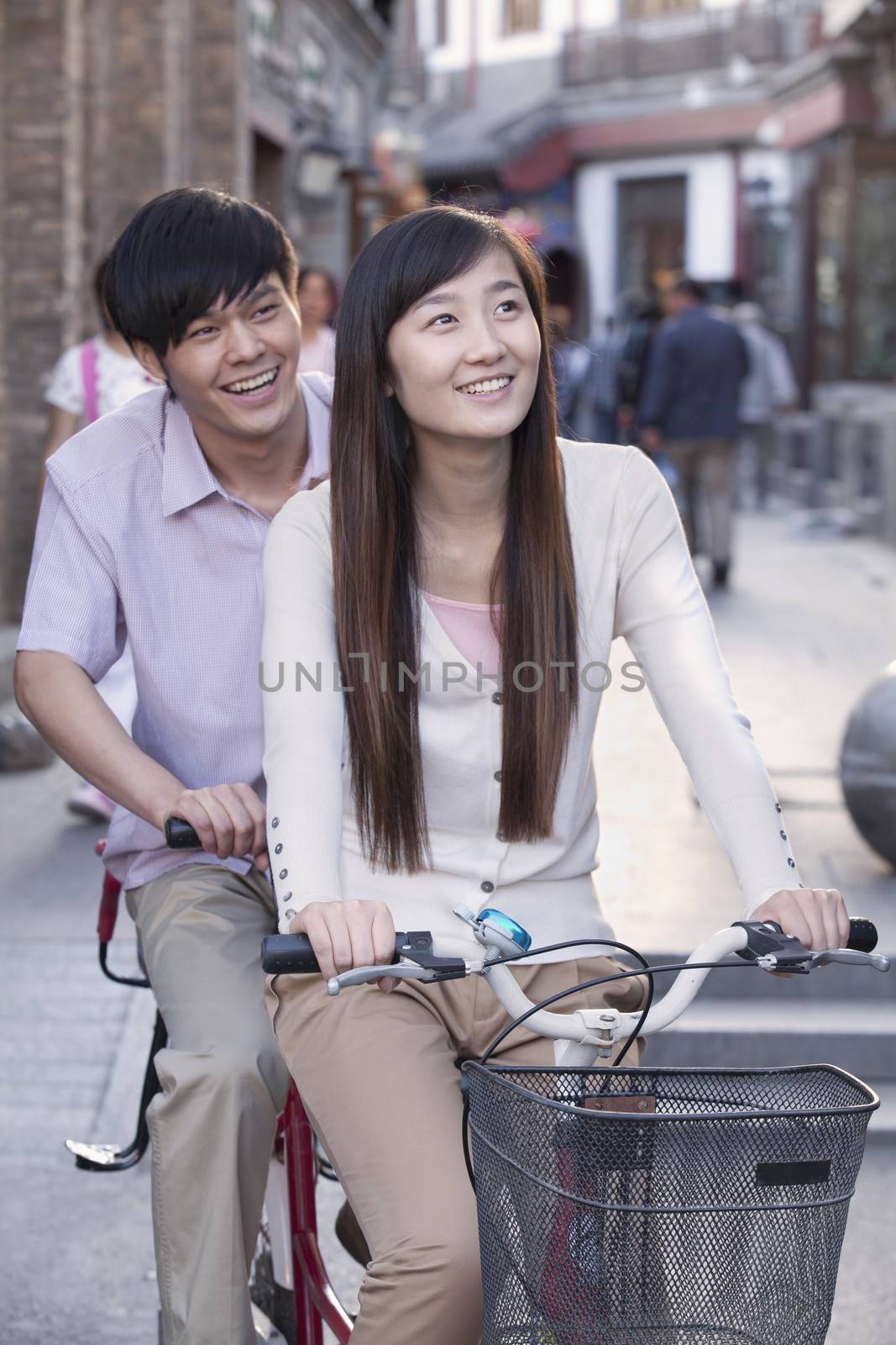 Young Heterosexual Couple on a Tandem Bicycle in Beijing by XiXinXing