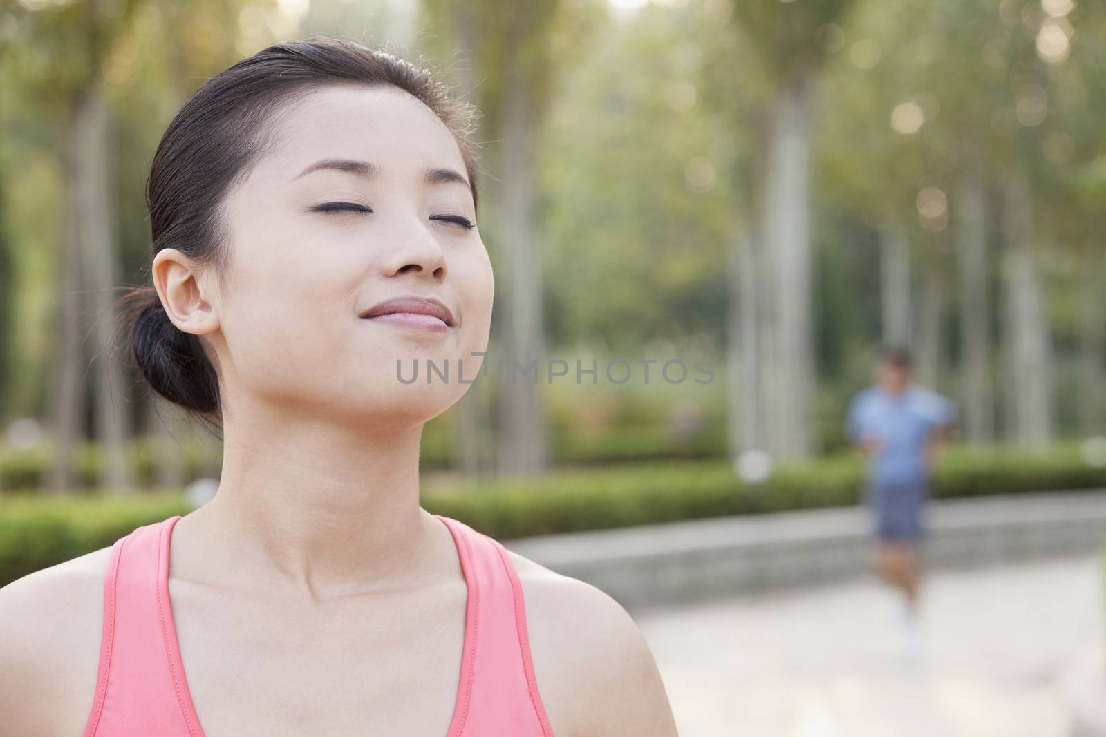 Young Woman With Eyes Closed in Park in Beijing by XiXinXing