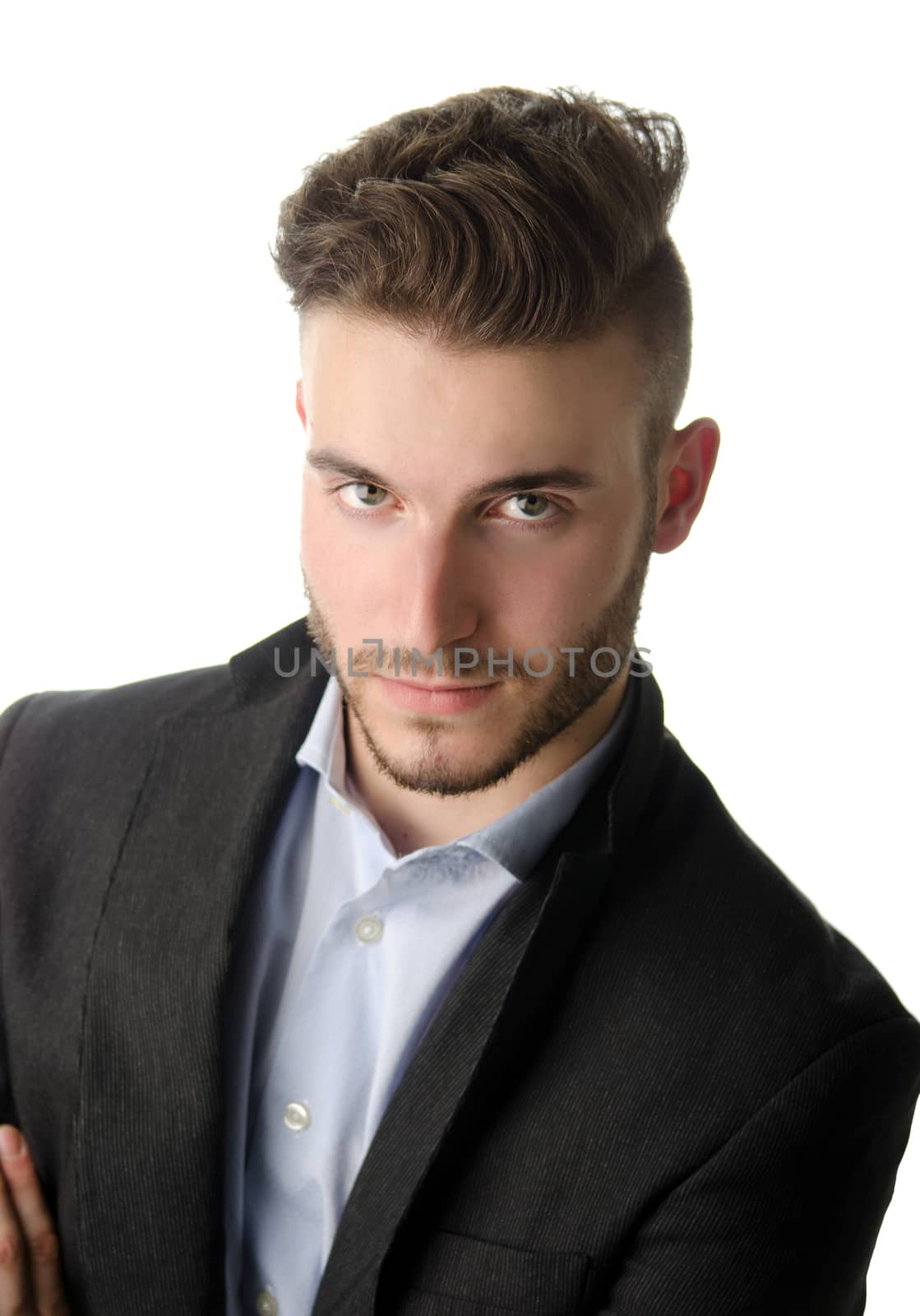 Studio portrait of attractive young businessman looking in camera, on white background