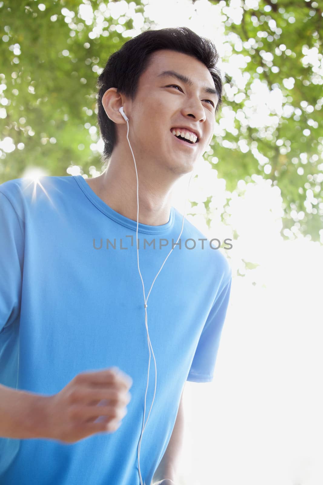 Young Man Jogging While Listening to Music