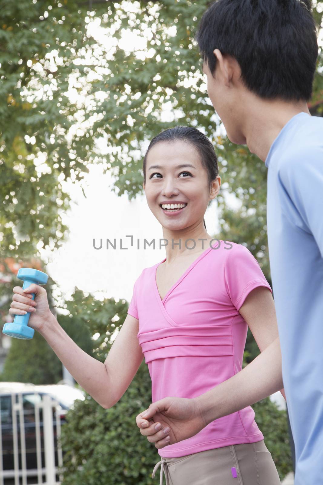 A Young Couple Jogging in Park