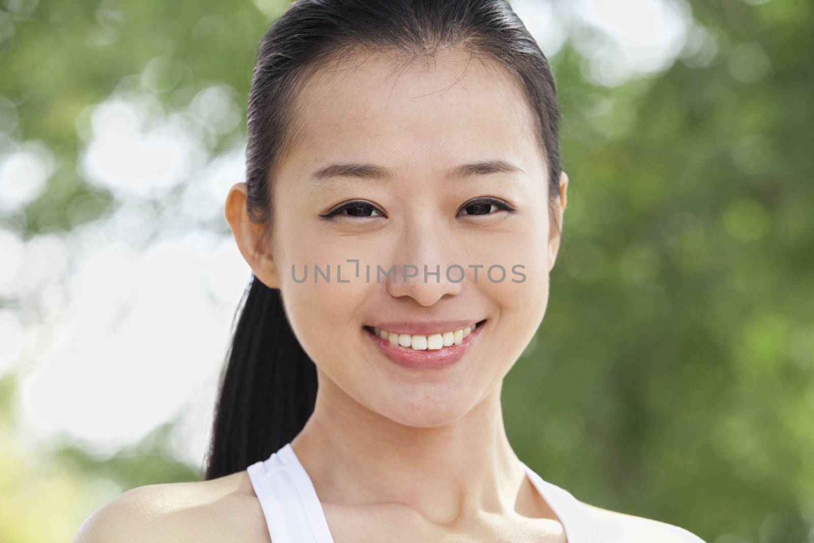 Portrait of Young Woman in Park