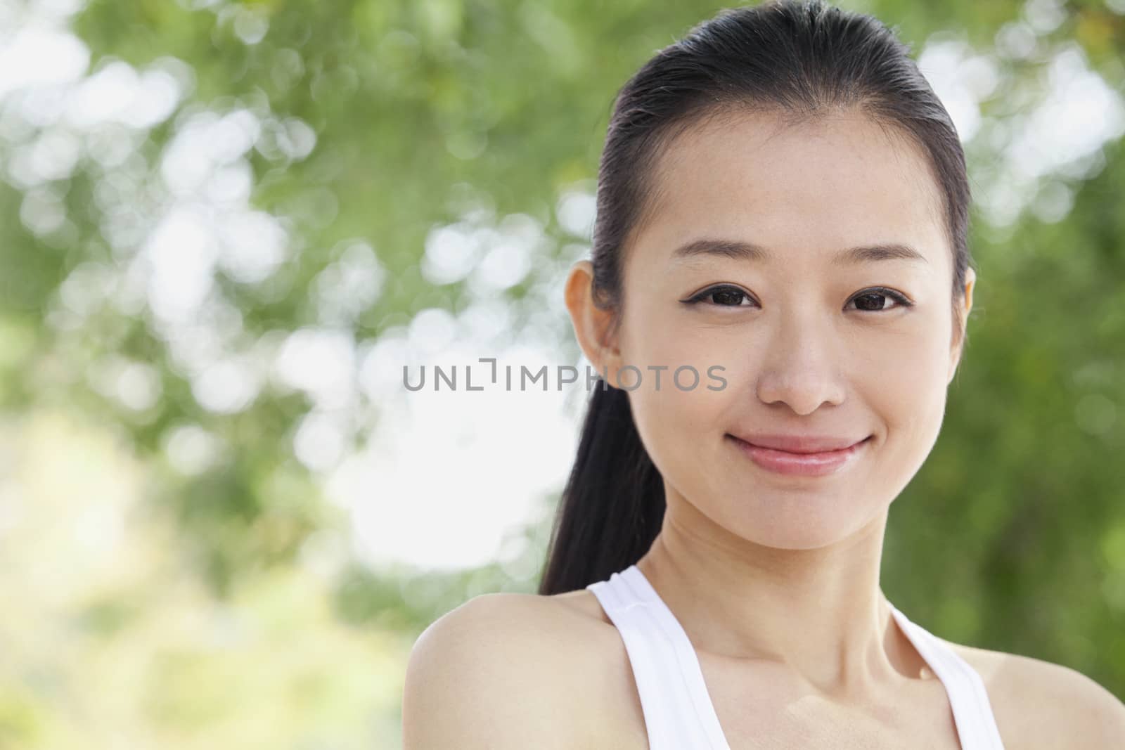 Portrait of Young Woman in Park