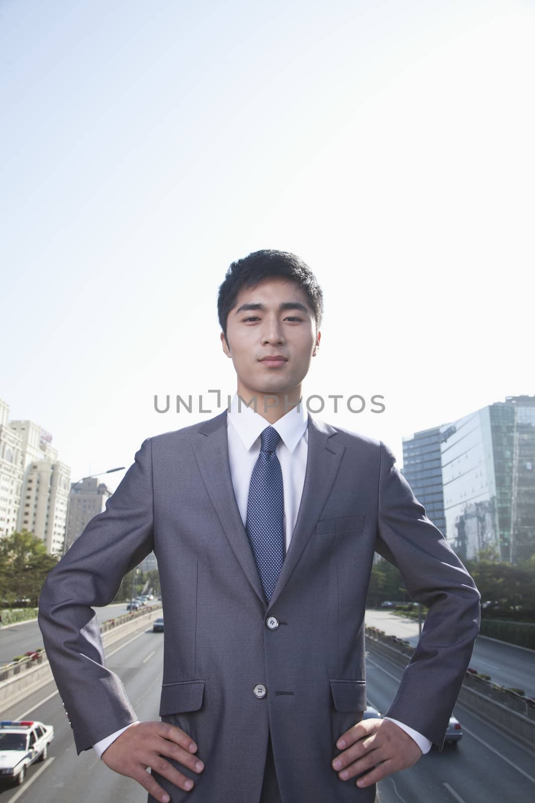 Young Businessman  Looking at Camera by XiXinXing