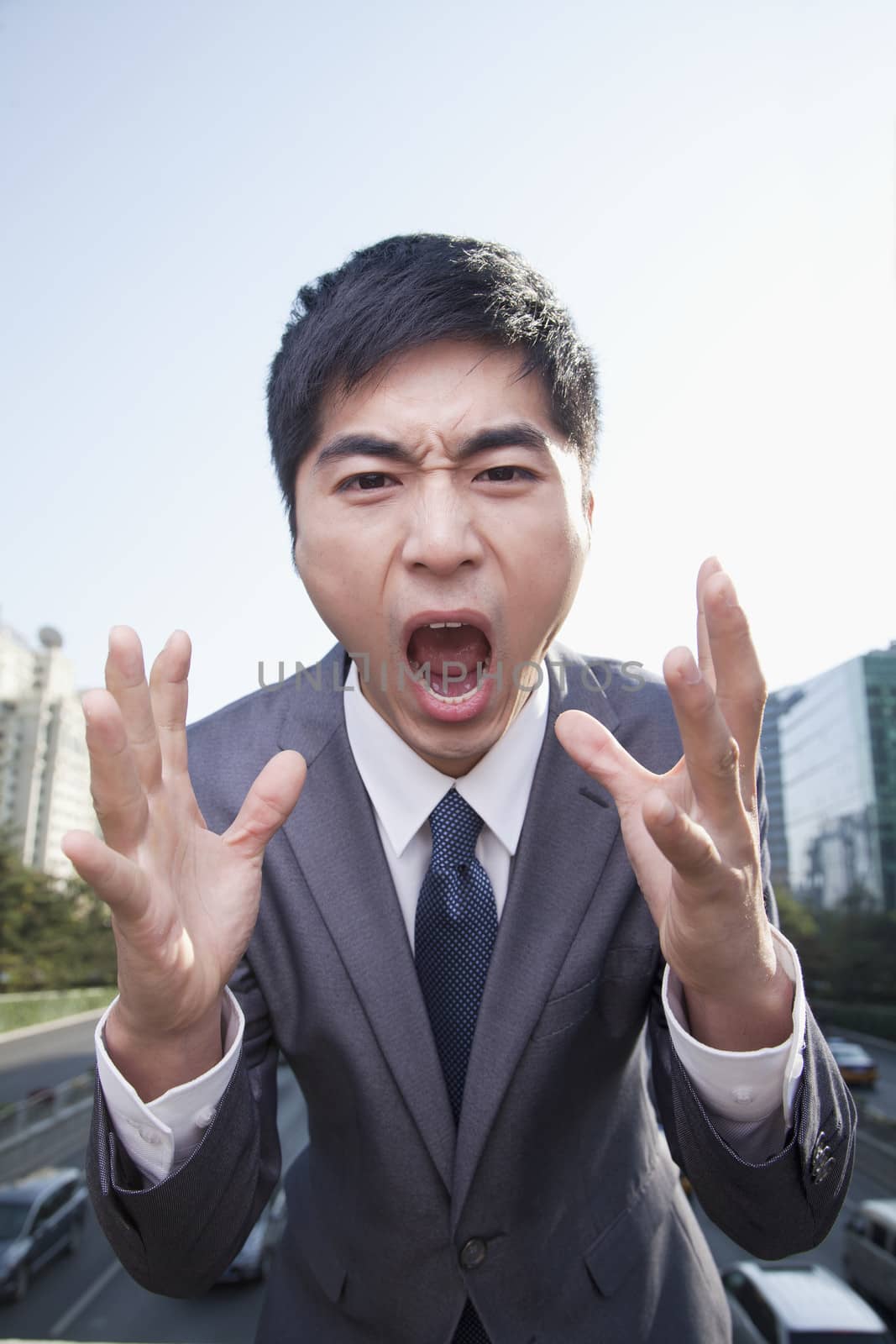 Young Angry Businessman Yelling by XiXinXing