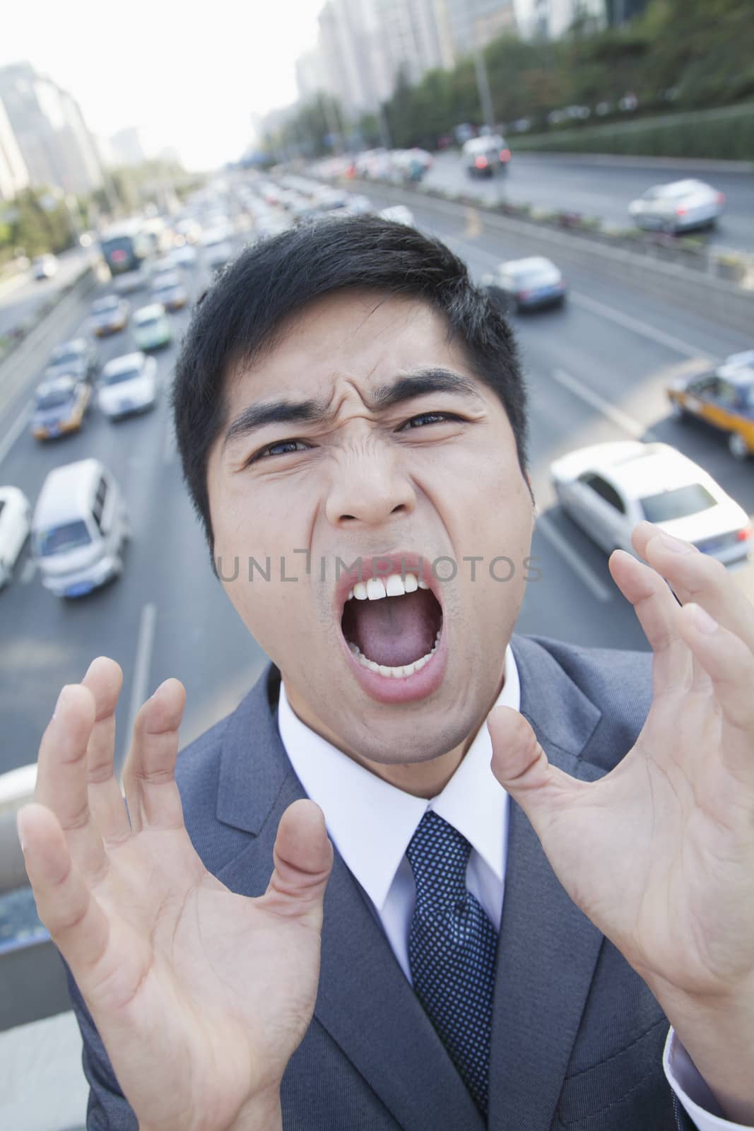 Young Angry Businessman Yelling Over Freeway by XiXinXing