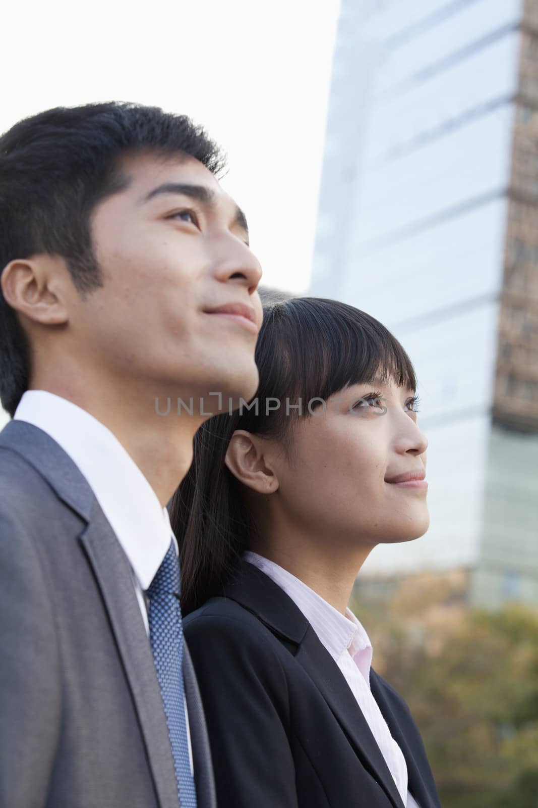 Young Business Colleagues Looking Away by XiXinXing