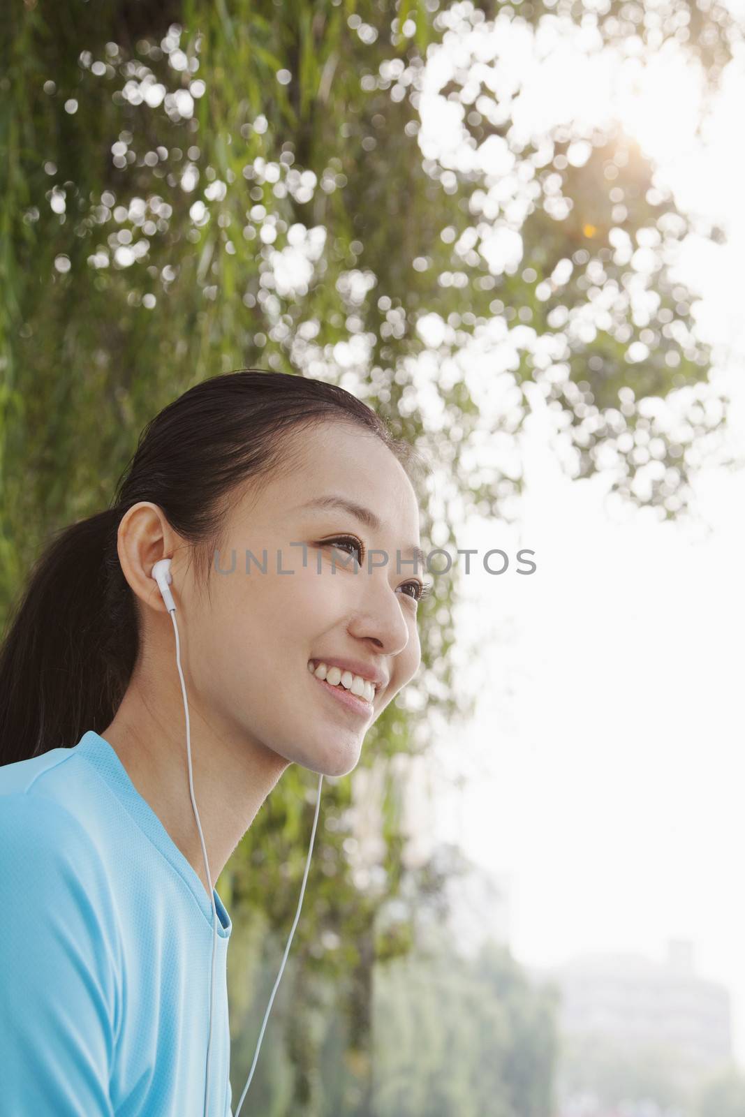 Young Woman Listening to Music by XiXinXing