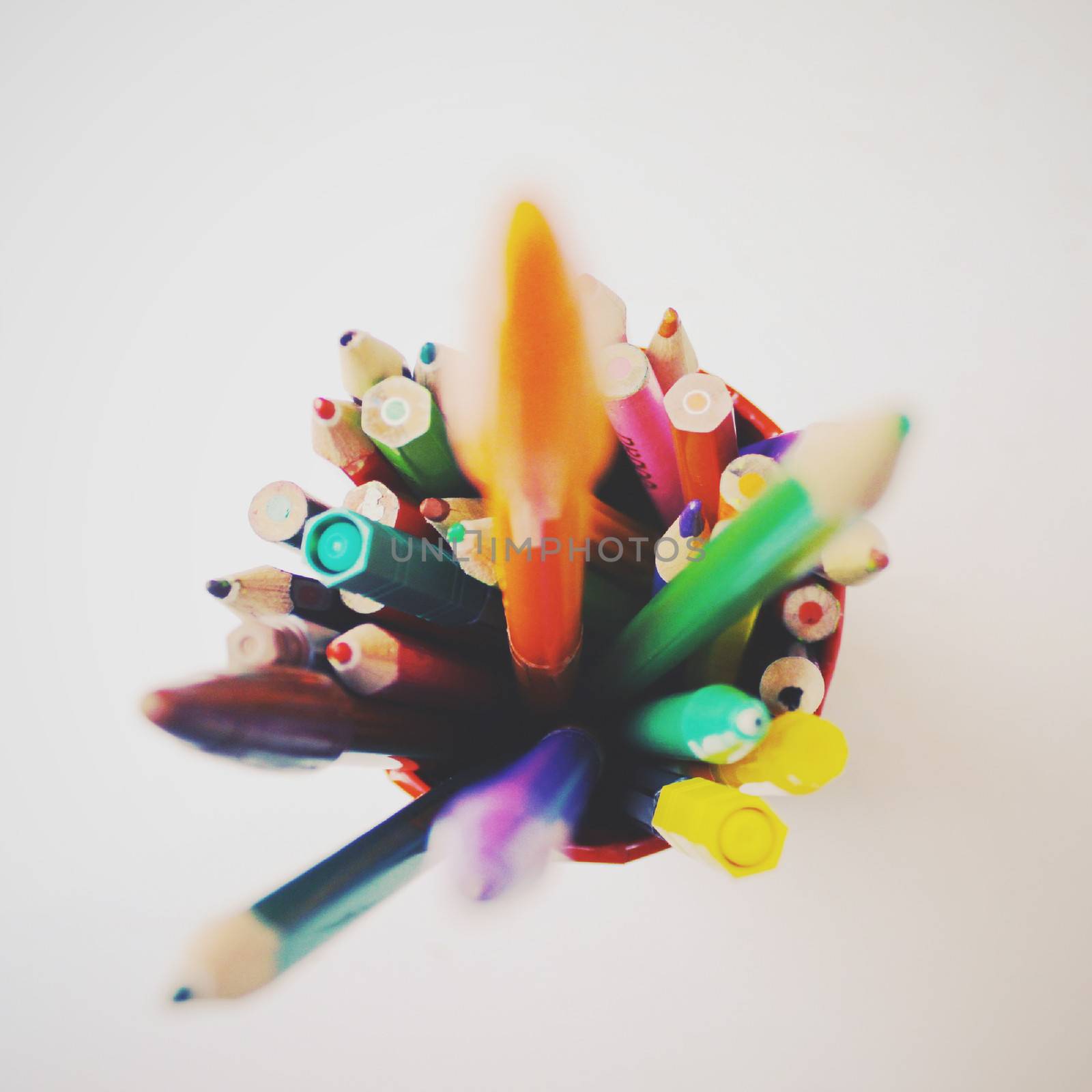 Group of crayons and pens with retro filter effect