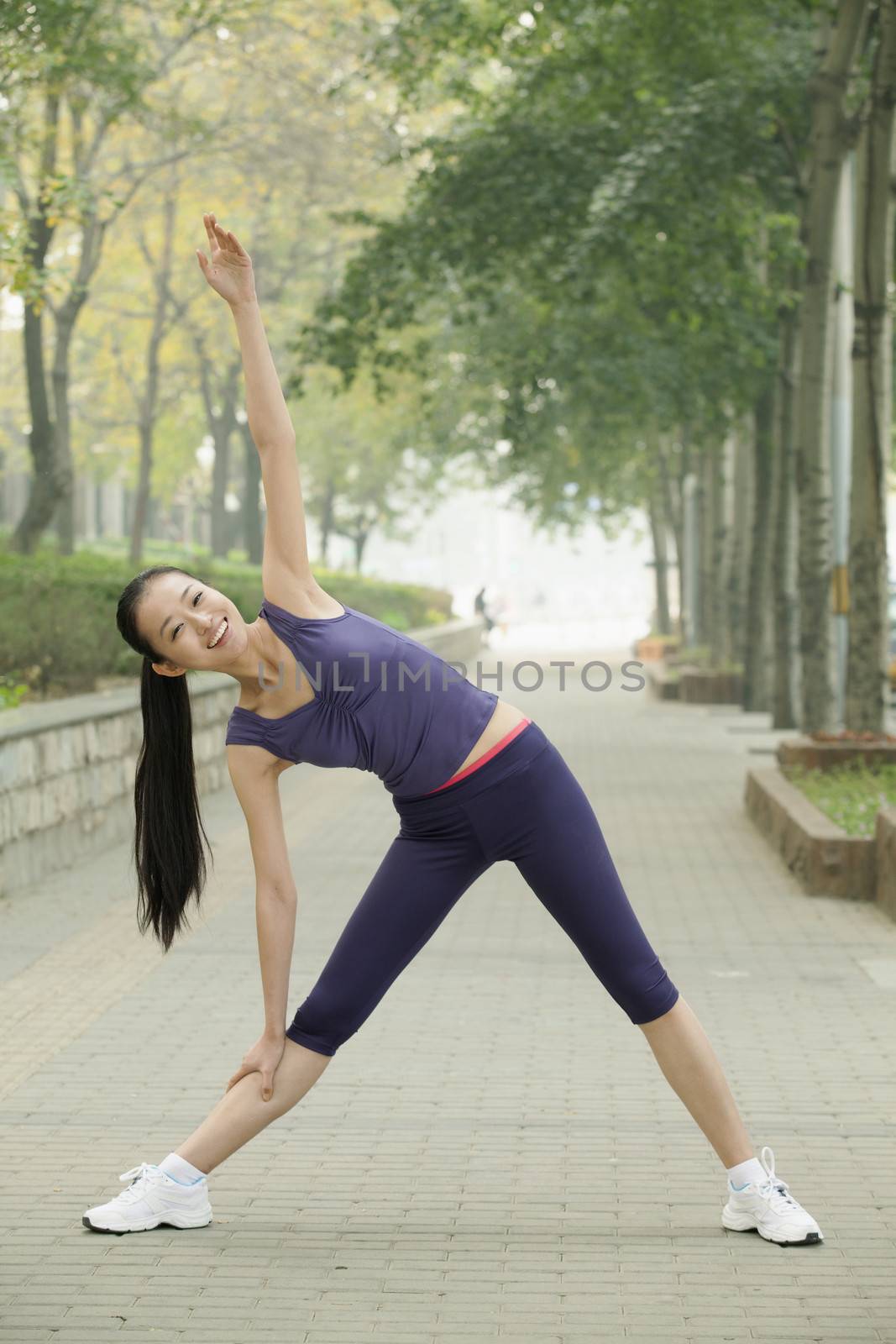 Young woman stretching in the park
