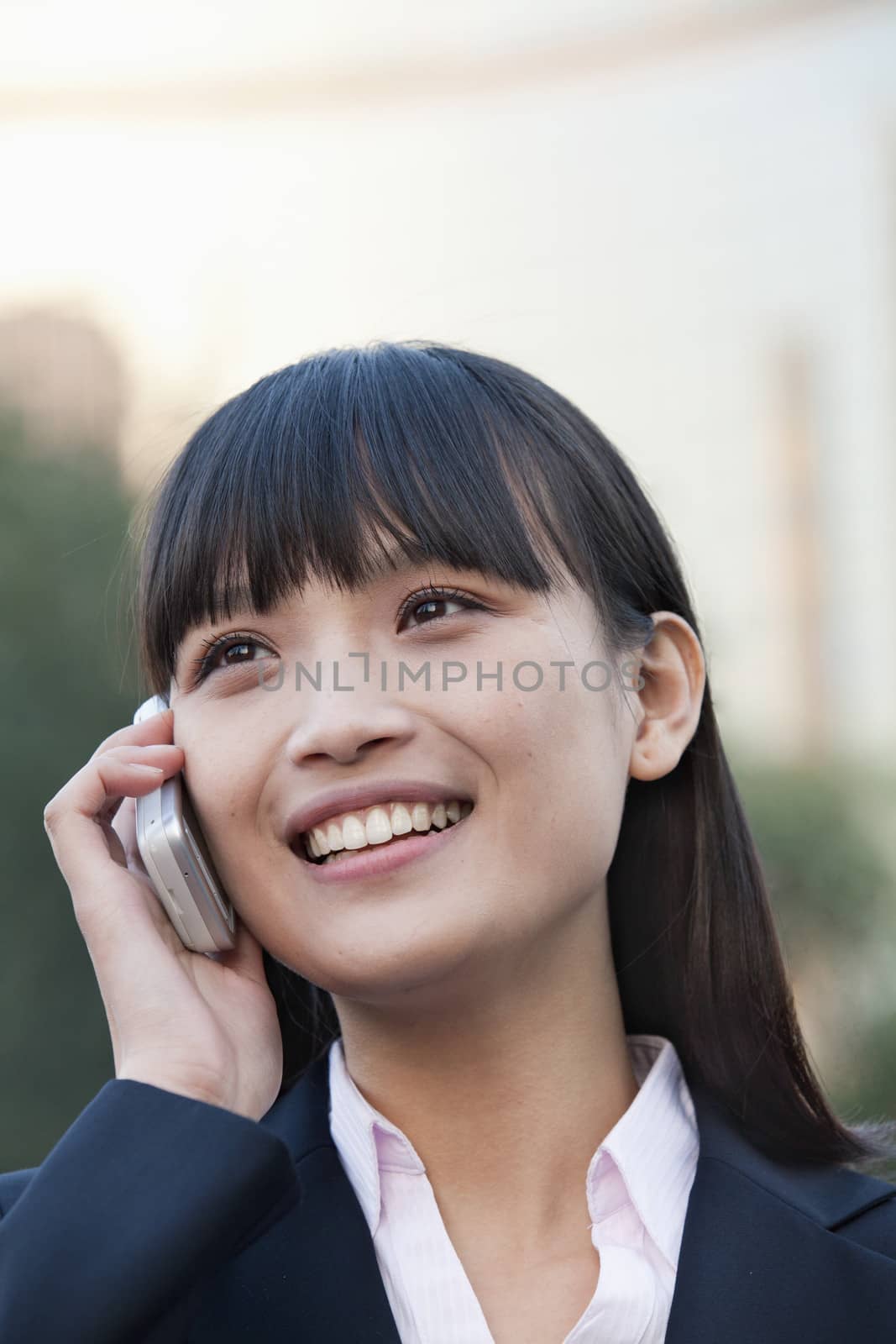 Young Businesswoman Talking on Cell phone by XiXinXing