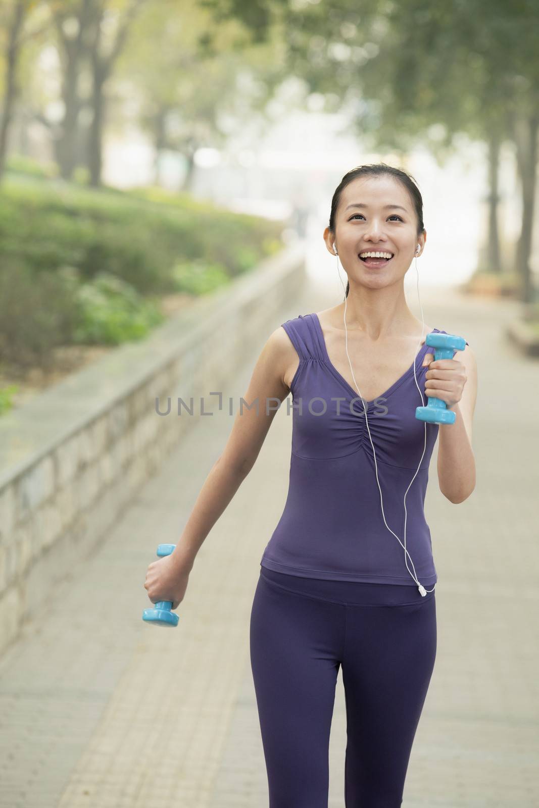 Young woman exercise in the park by XiXinXing