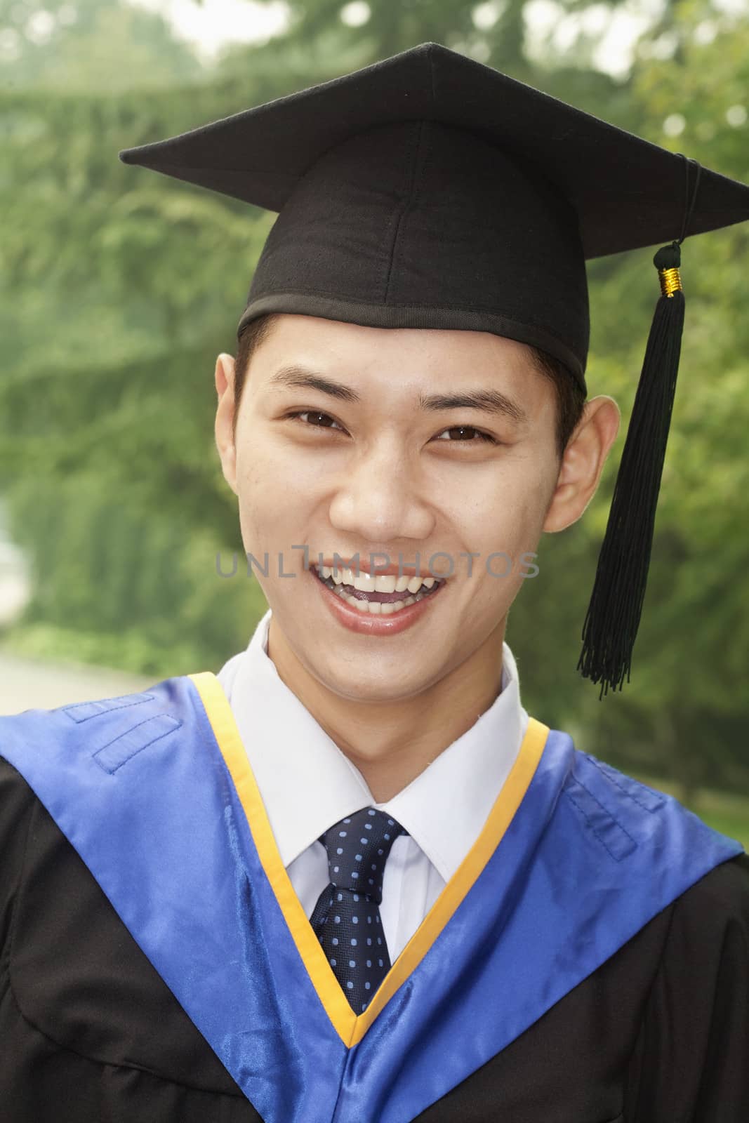 Young Man Graduating From University, Close-Up Portrait by XiXinXing
