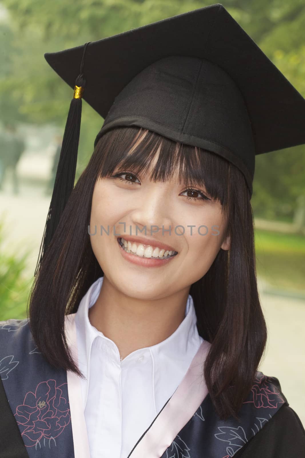Young Woman Graduating From University, Close-Up Portrait by XiXinXing