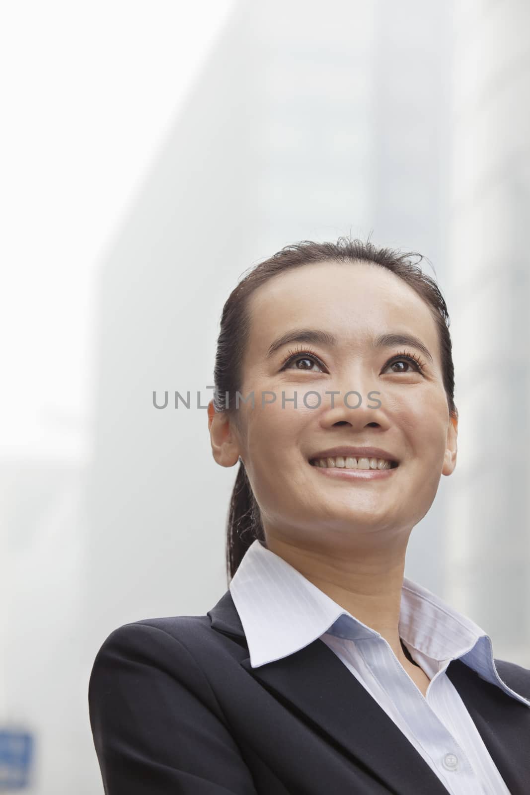 Young Businesswoman Smiling and Looking into the Distance