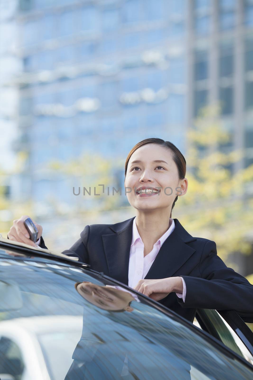 Businesswoman Standing by Car Looking Away