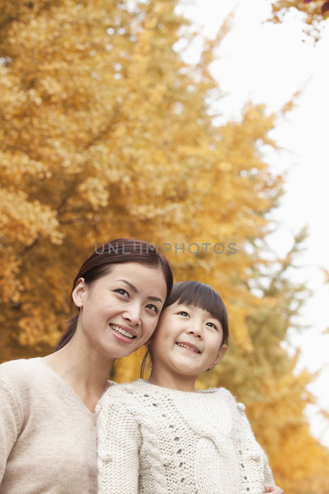 Mother and Daughter Enjoying a Park in Autumn