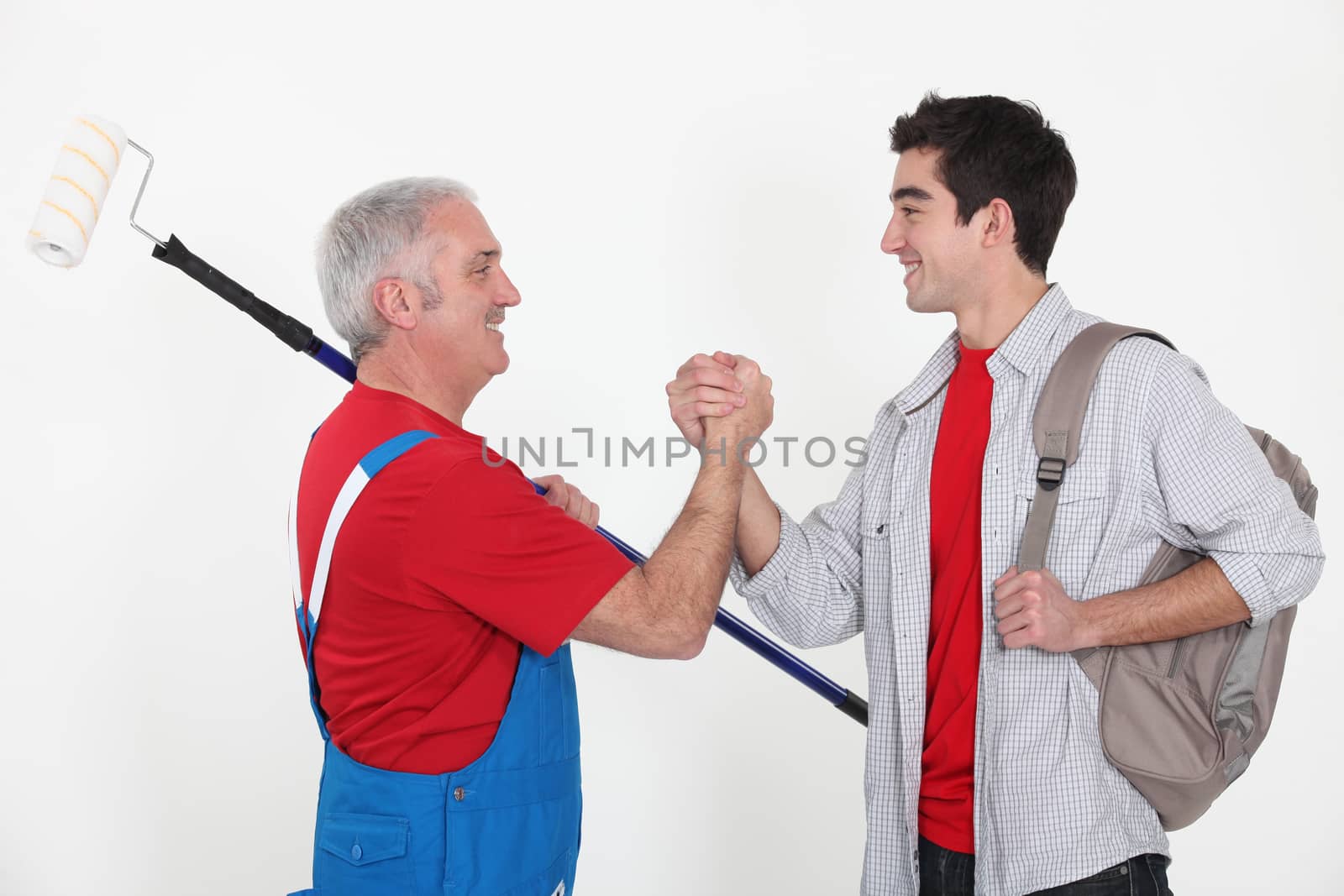 craftsman and apprentice shaking hands