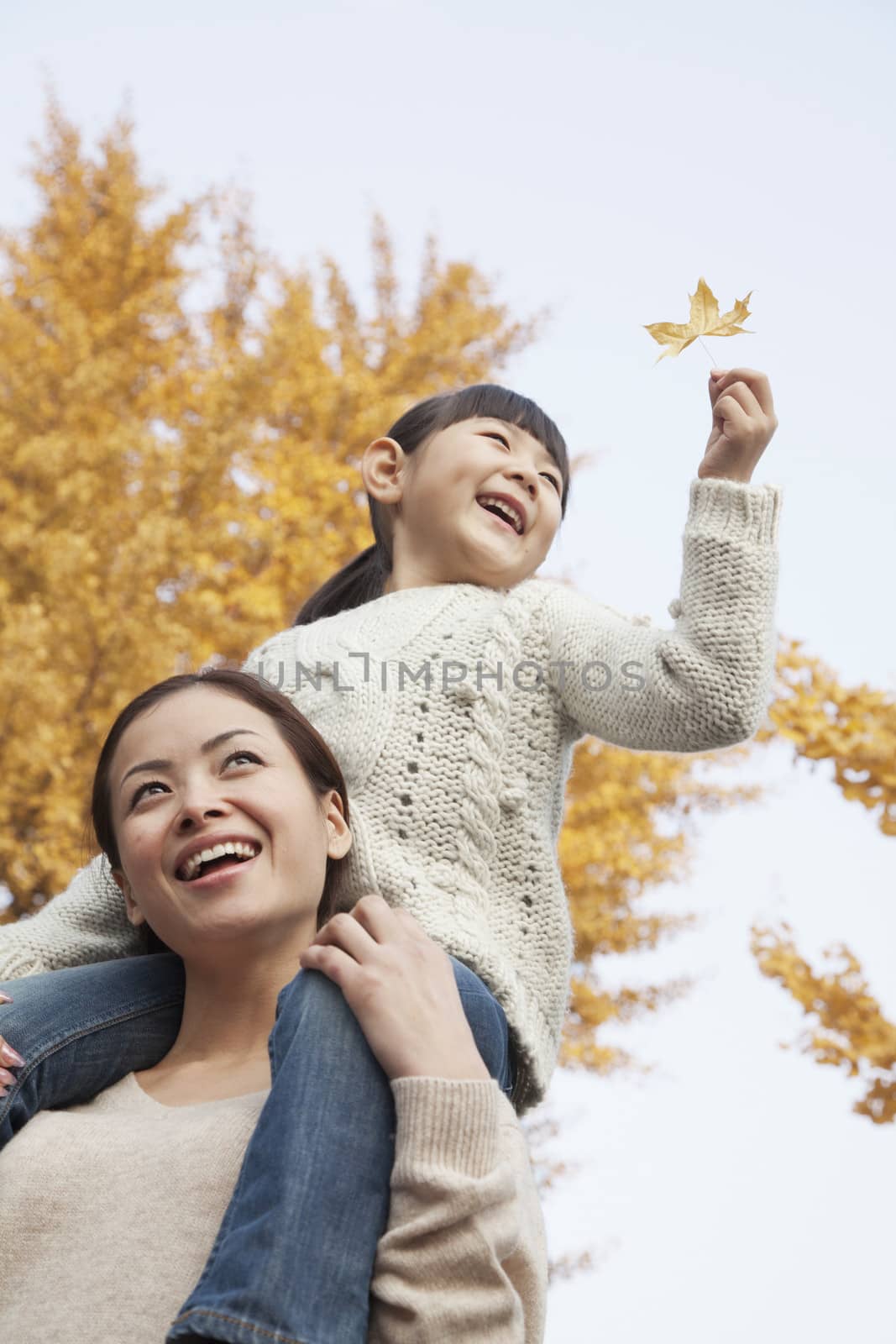 Mother and Daughter Enjoying a Park in Autumn by XiXinXing