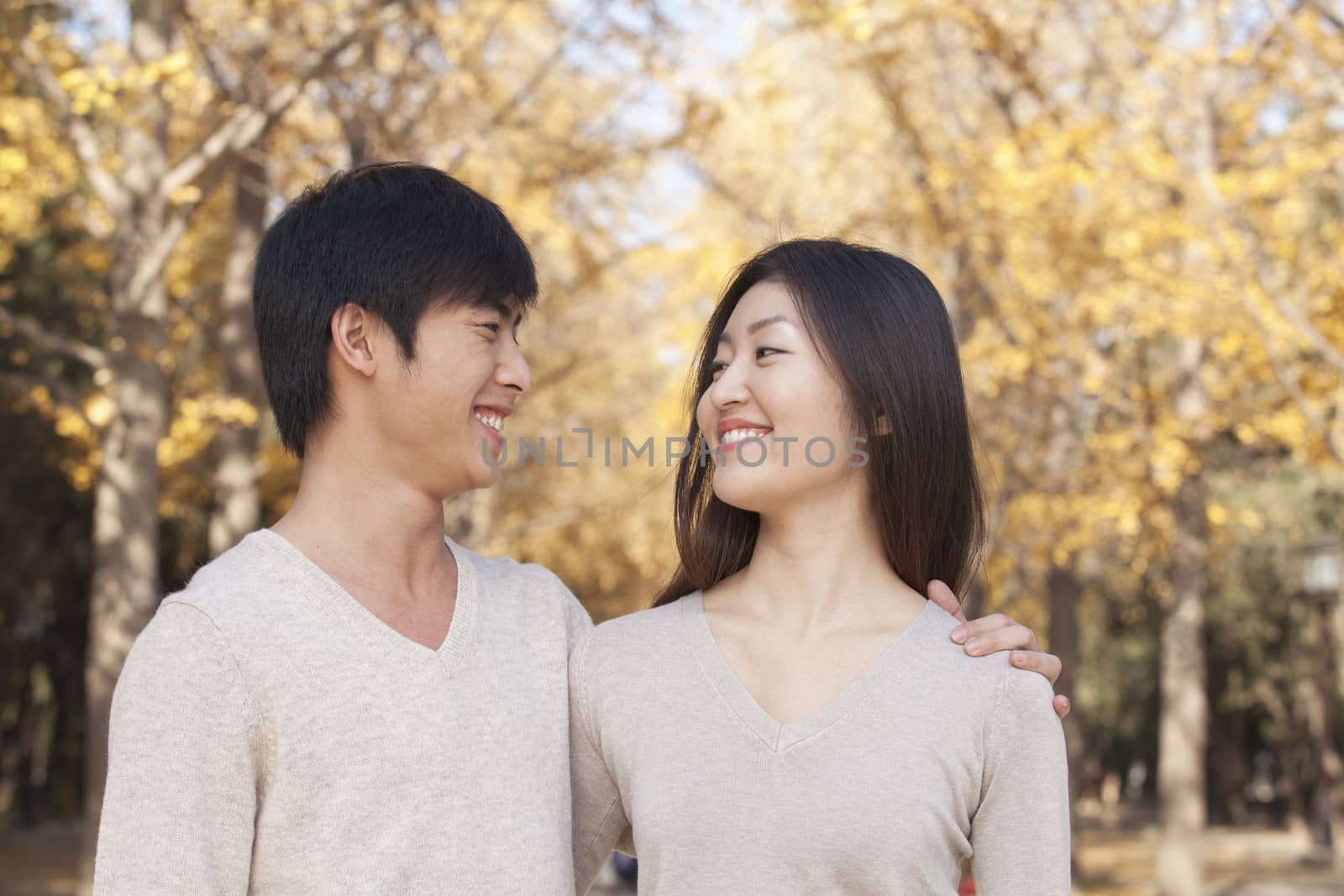 Young Couple in the Park in Autumn by XiXinXing