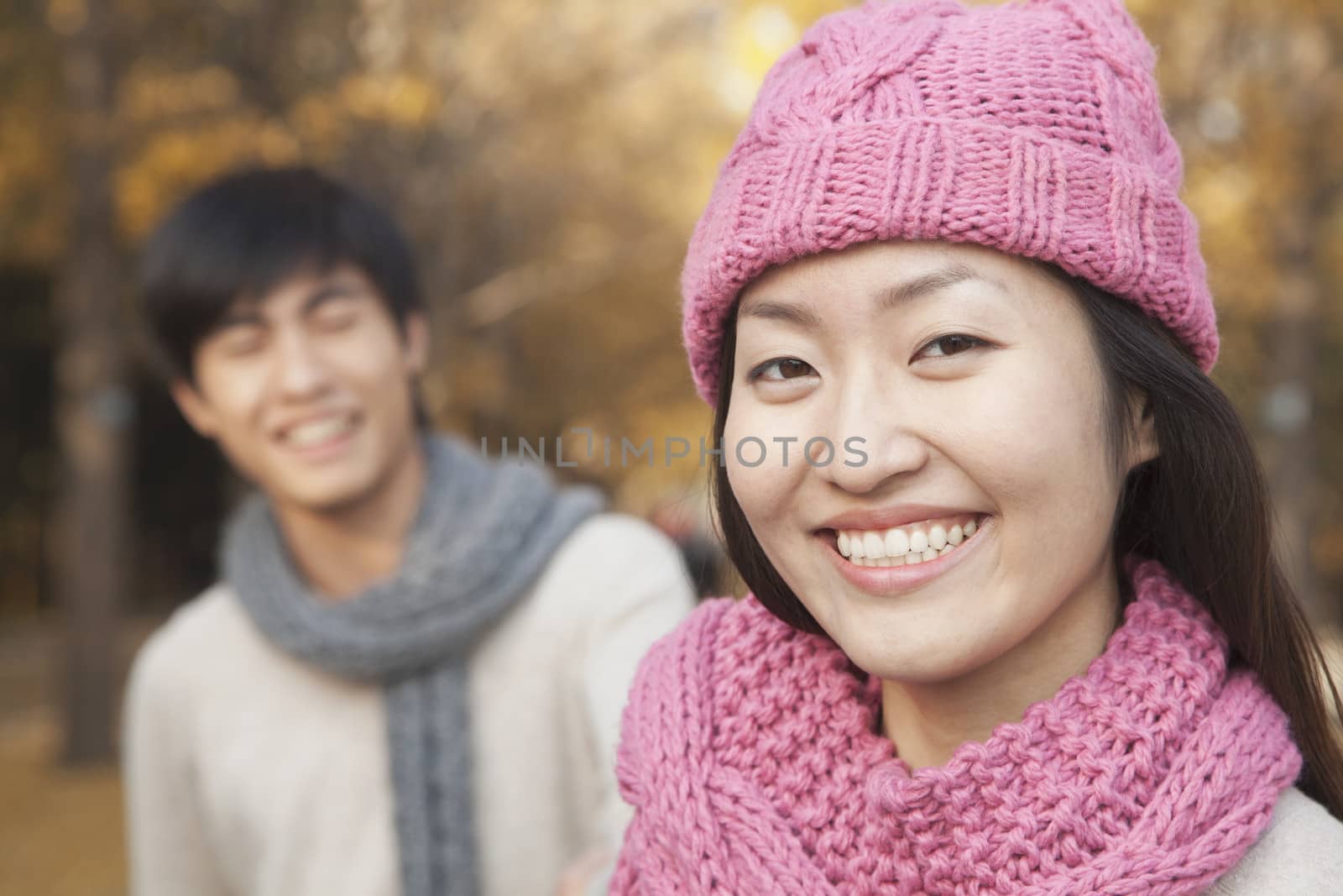 Close Up of Young Woman with her Boyfriend in Park in Autumn by XiXinXing