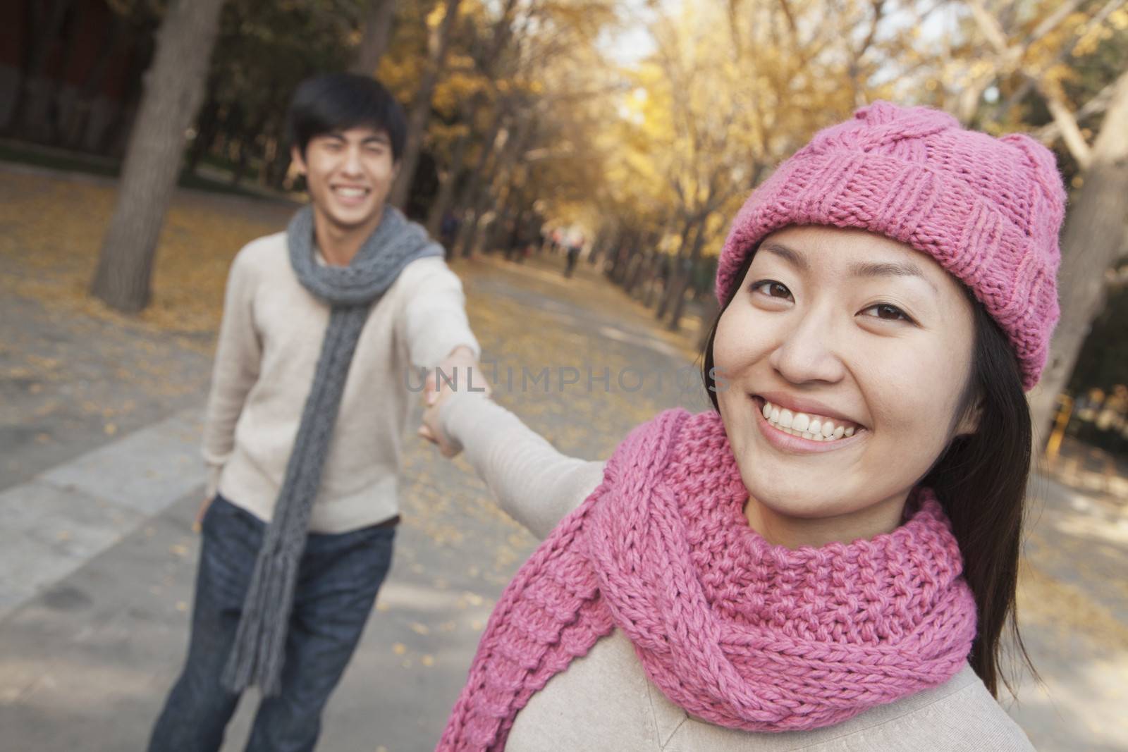 Portrait of Smiling Couple Holding Hands in Park