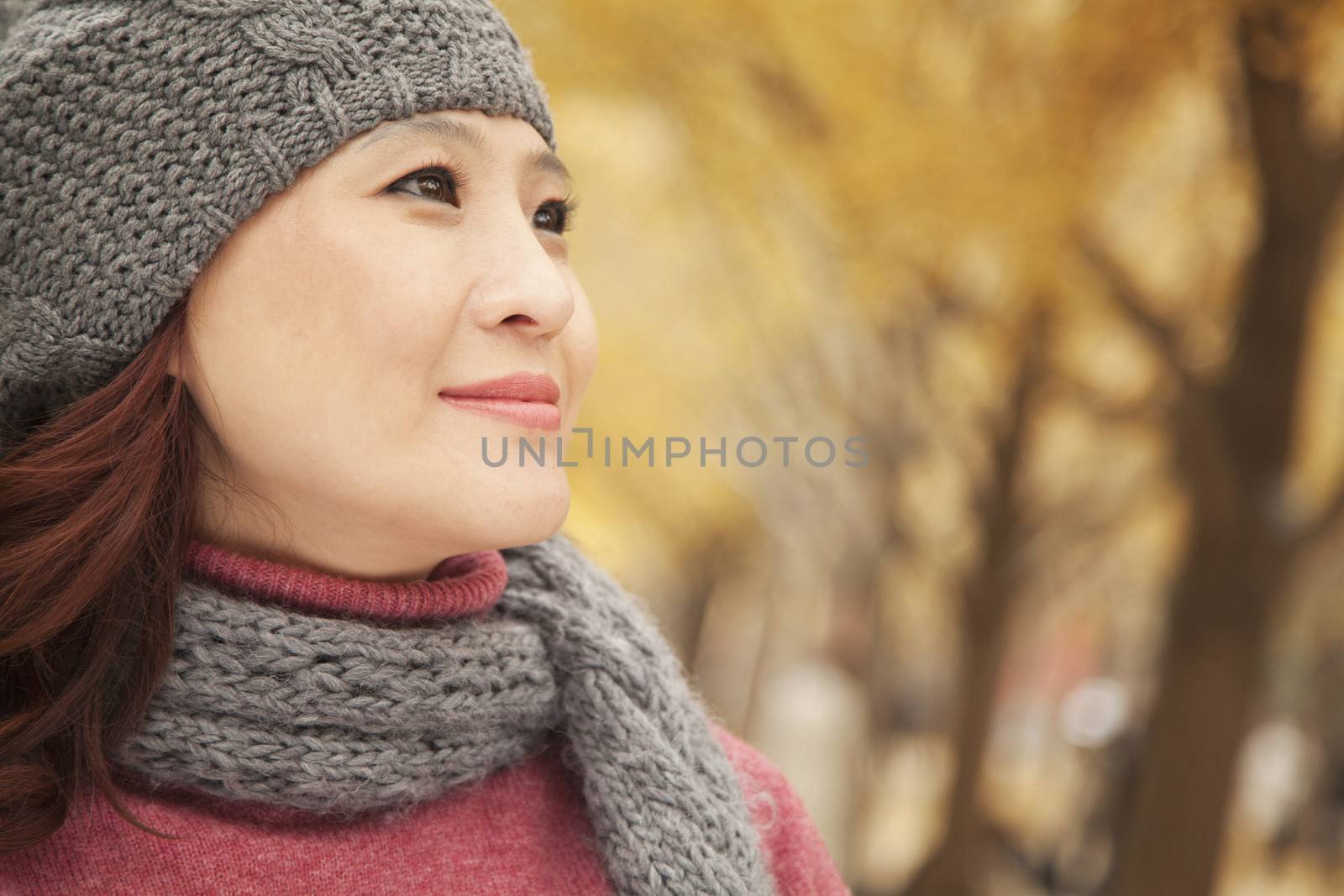 Mature Woman Enjoying a Park in Autumn