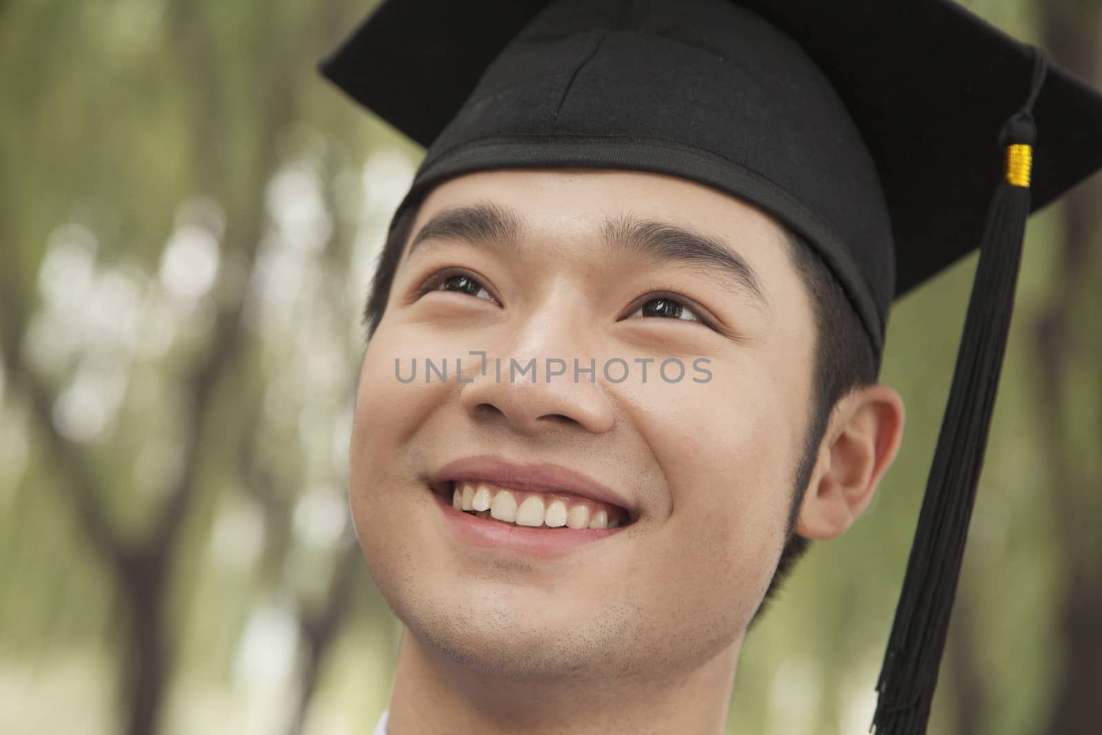 Portrait Of A Young Univercity Graduate Looking Up