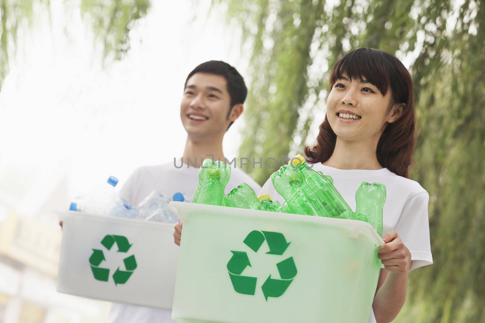 Two Young People Recycling Plastic Bottles by XiXinXing