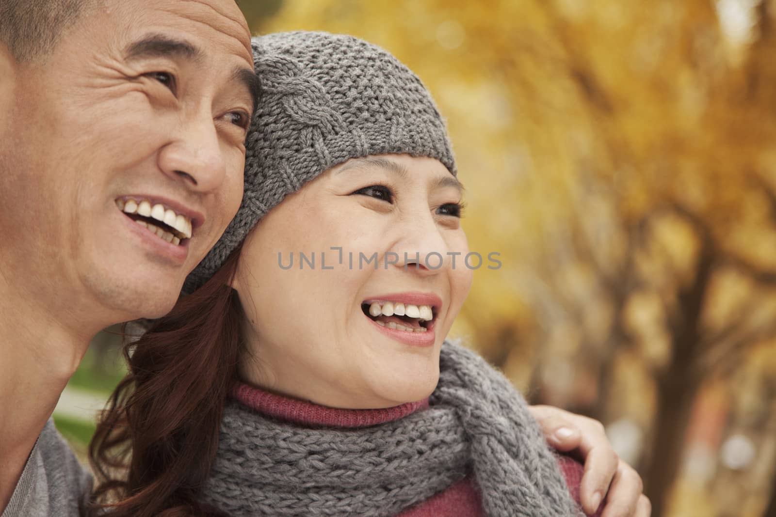 Mature Couple Embracing in Park by XiXinXing