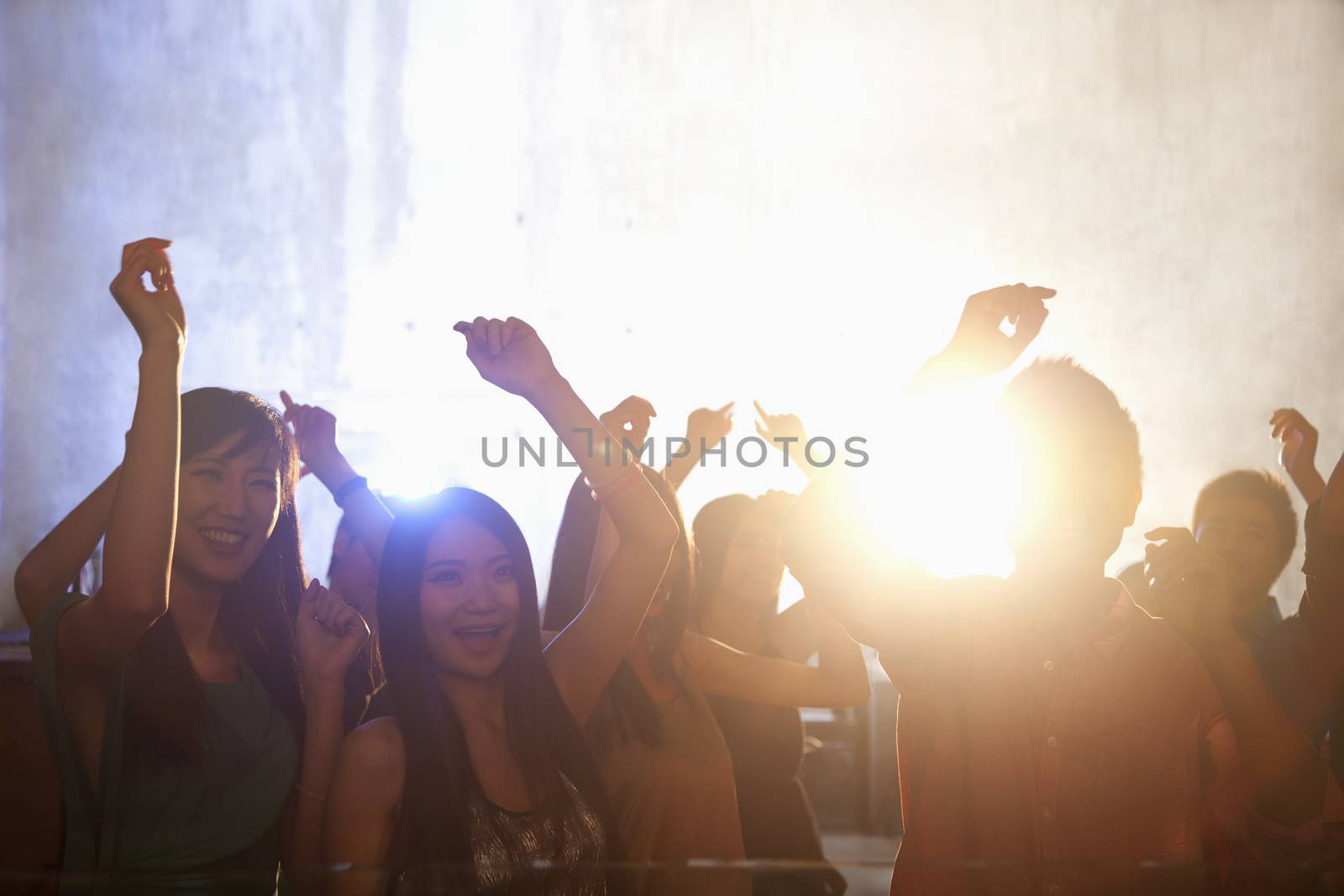 A crowd of young people dancing in a nightclub