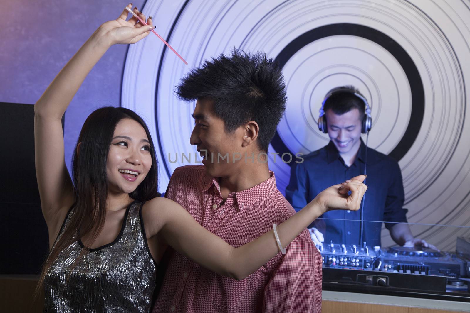 A young couple dancing in nightclub by XiXinXing