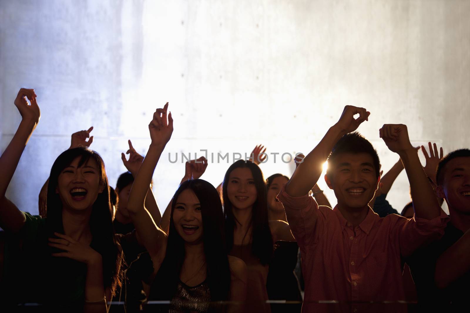A crowd of young people dancing in a nightclub by XiXinXing