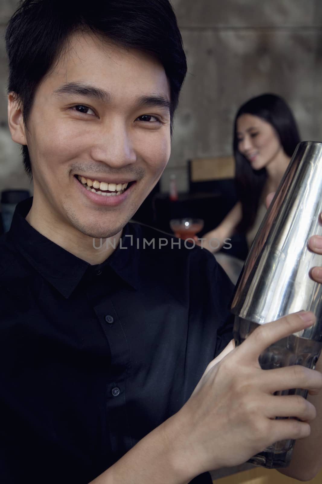 Portrait of a bartender making cocktails by XiXinXing