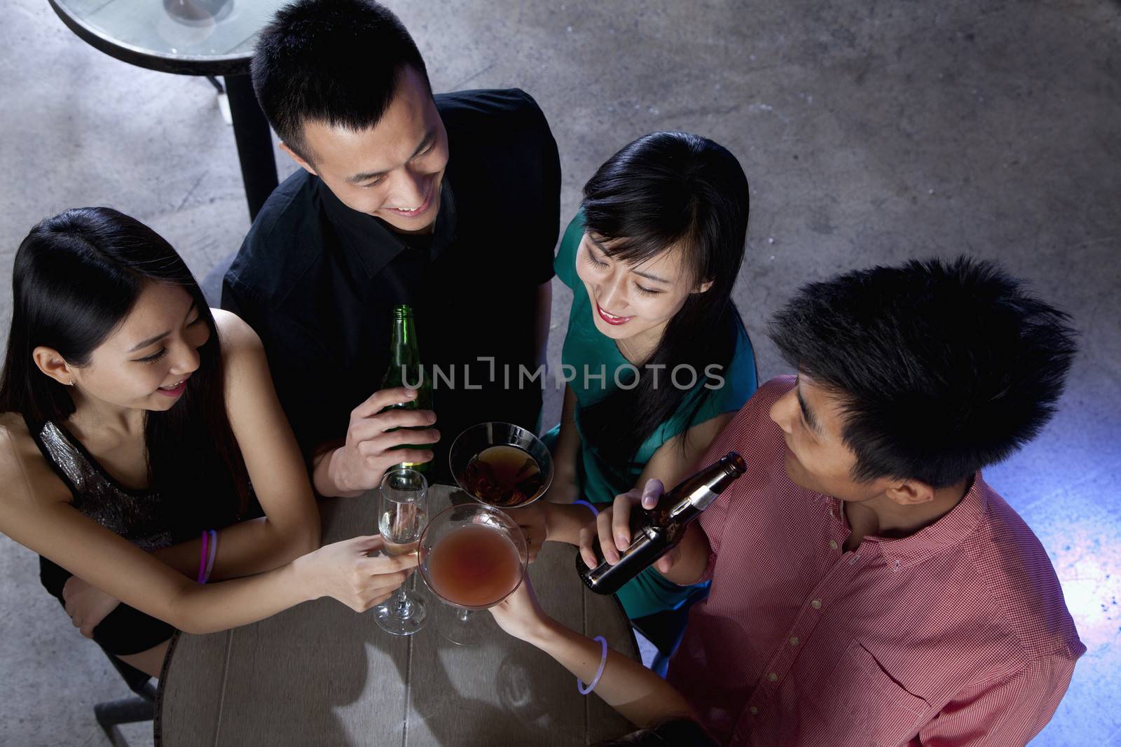 A group of friends having drinks in nightclub by XiXinXing