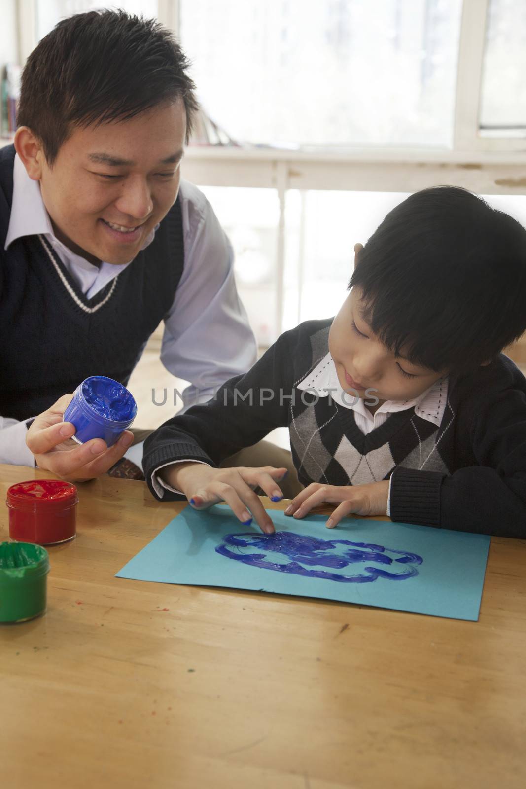 Teacher and student finger painting in art class by XiXinXing